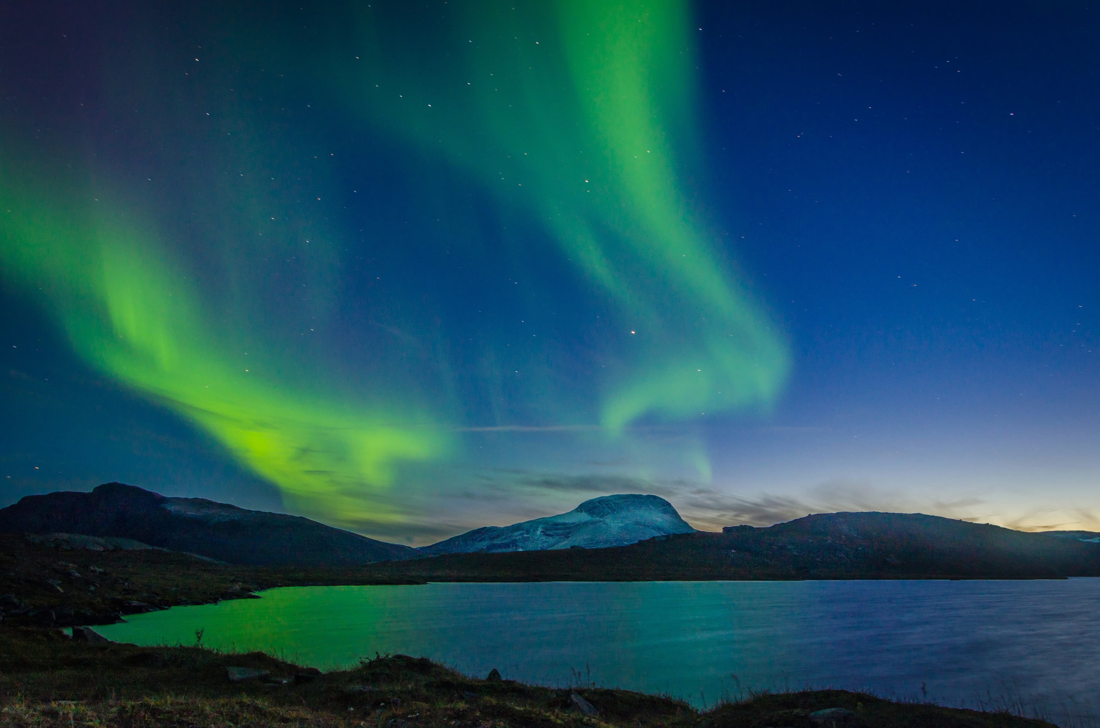 Northern lights (aurora borealis) reflected over a Swedish lake at night